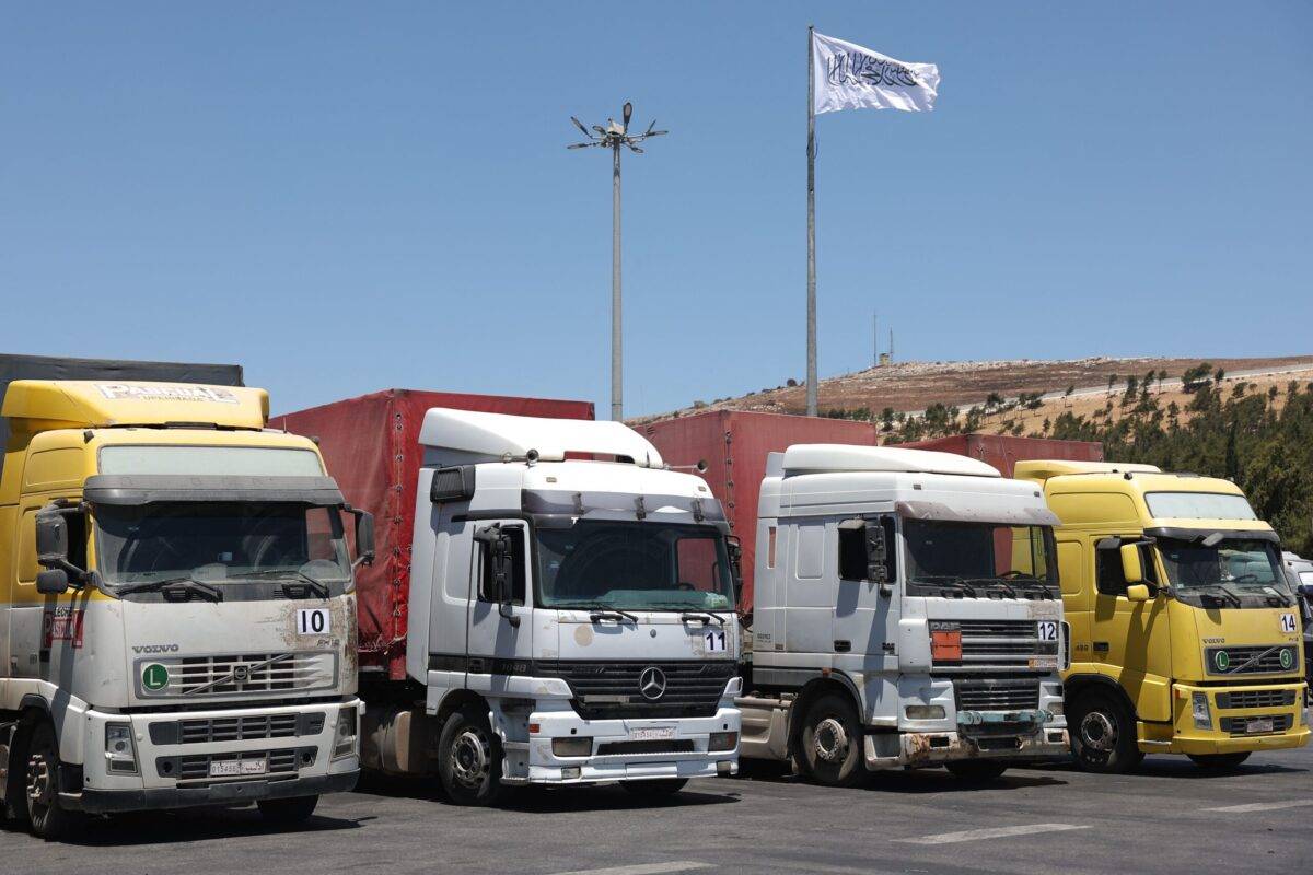 A convoy of trucks carrying humanitarian aid is seen parked after crossing the Syrian Bab al-Hawa border crossing with Turkey, on July 10, 2023 [OMAR HAJ KADOUR/AFP via Getty Images]