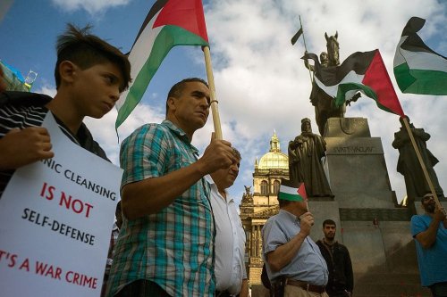 Pro-Palestinian protesters holding banners and Palestinian flags attend a rally in solidarity with Palestinians killed in Israeli assaults in Gaza on July 24, 2014 in Prague. [MICHAL CIZEK/AFP/Getty Images]
