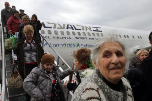 Jewish new immigrants from Ukraine, who are making Aliyah (Immigration to Israel), walk down the stairs as their airplane lands at Ben Gurion International airport on December 22, 2014, in Lod, about 15 kms east of Tel Aviv [GIL COHEN-MAGEN/AFP via Getty Images]