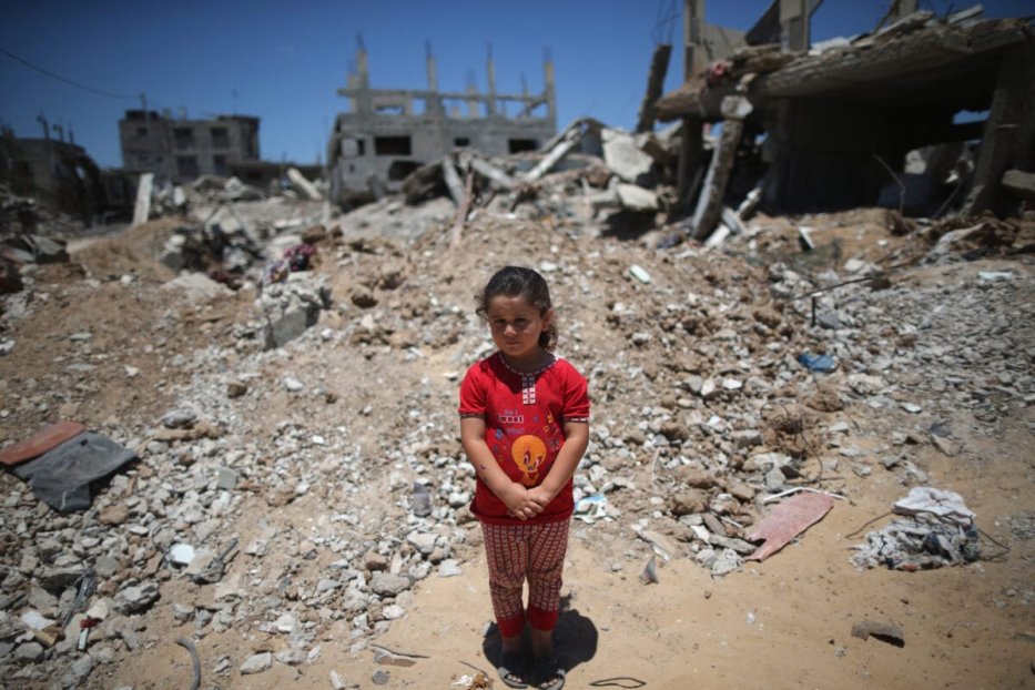 Fatima Shamaly, aged four, stands amongst the devastation and rubble during a music workshop for traumatised children [Christopher Furlong/Getty Images]