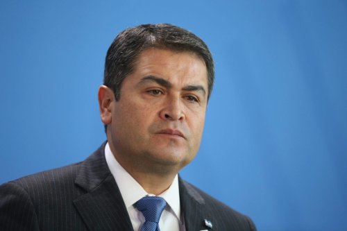 Honduran President Juan Orlando Hernandez speaks to the media with German Chancellor Angela Merkel (not pictured) following talks at the Chancellery on 27 October 2015 in Berlin, Germany. [Sean Gallup/Getty Images]