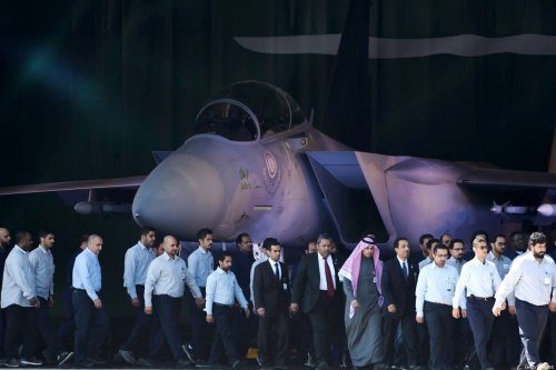 Saudi Air Force officers and technical staff walk past an advanced F-15SA fighter jet during ceremony marking the 50th anniversary of the creation of the King Faisal Air Academy at King Salman airbase in Riyadh [FAYEZ NURELDINE/AFP via Getty Images]