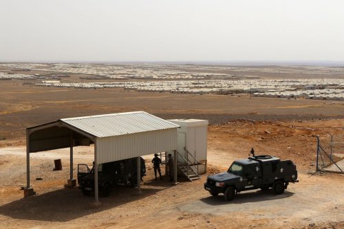 A Photo shows police vehicles guard at the Azraq camp for Syrian refugees, the newest camp in Jordan that hosts 54.000 refugees in northeastern desert in Azraq, Jordan, on 13 July 2017. [Jordan Pix/ Getty Images]