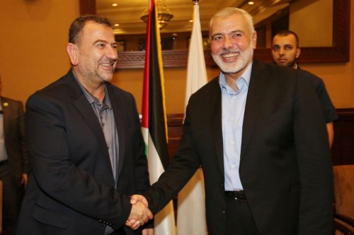 Palestinian Hamas Chief Ismail Haniyeh shakes hands with Hamas Deputy Chief Saleh al-Arouri, in Gaza City 2 August 2018 [Hamas Chief Media Office/ApaImages]