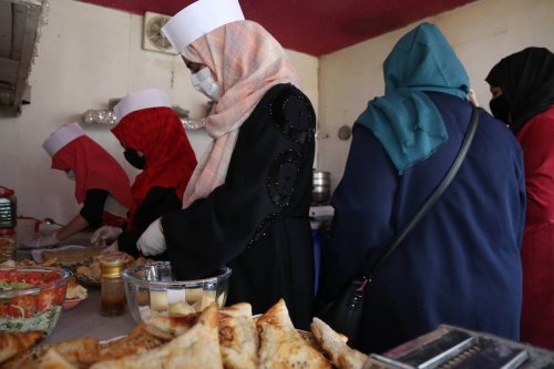 Employees of the first women restaurant, opened for girls and women customers, pose for a photo in Kabul, Afghanistan [Haroon Sabawoon]
